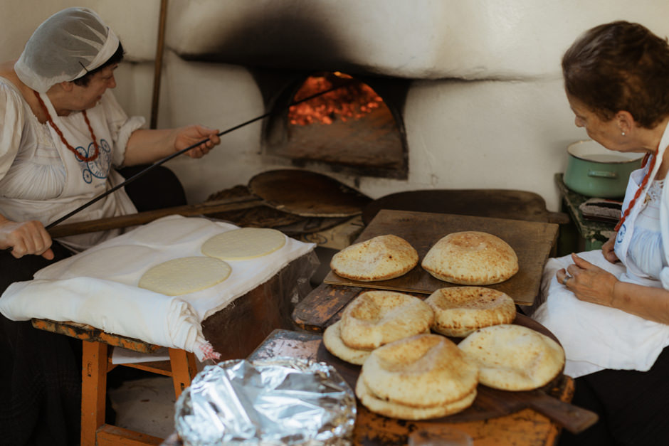old women making homemade bread at Hotel Su Gologone, central sardinia, Italy